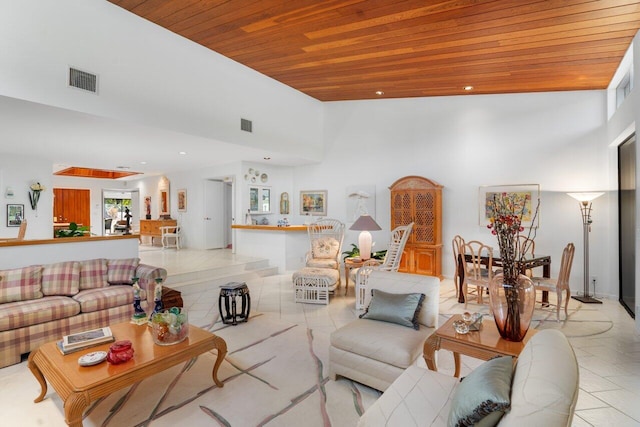 tiled living room featuring a towering ceiling and wooden ceiling