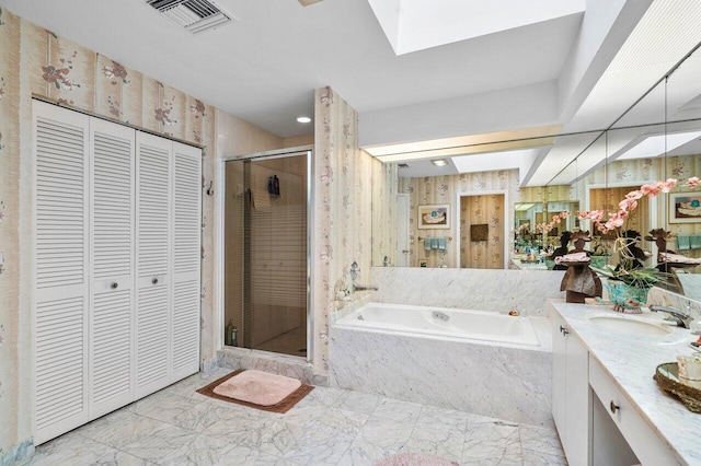 bathroom with vanity, plus walk in shower, and a skylight