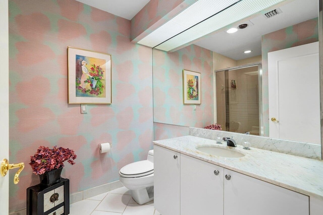 bathroom with vanity, toilet, a shower with shower door, and tile patterned flooring