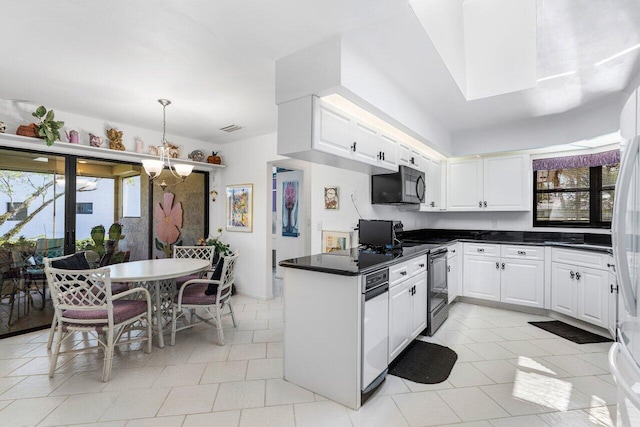 kitchen featuring white cabinetry, stainless steel electric range oven, hanging light fixtures, and plenty of natural light