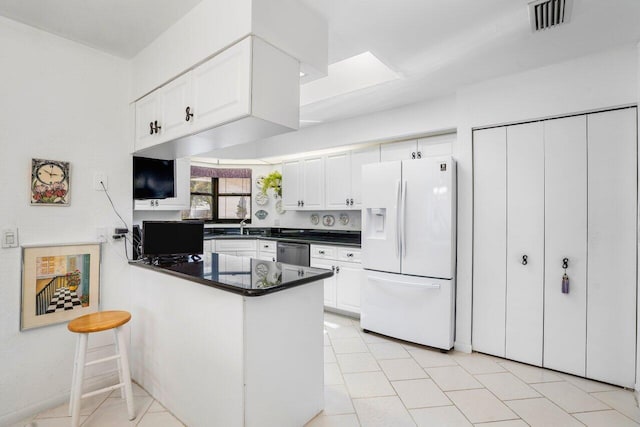 kitchen featuring white cabinets, dishwasher, white fridge with ice dispenser, and kitchen peninsula