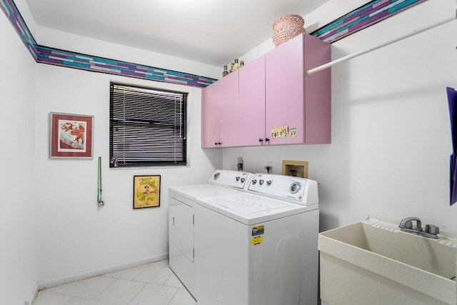 laundry room with sink, washer and clothes dryer, and cabinets