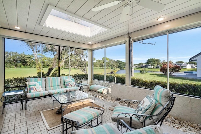 sunroom with ceiling fan and a skylight