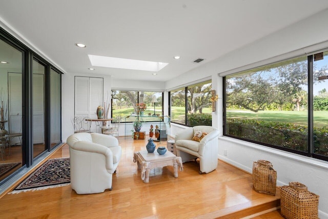 sunroom with plenty of natural light and a skylight