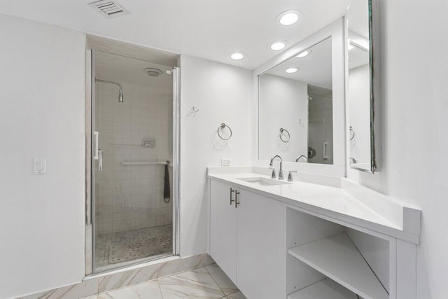 bathroom with vanity and a shower with shower door