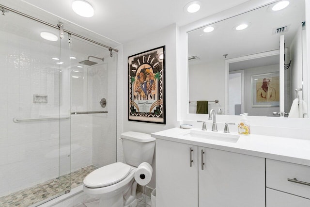 bathroom with vanity, an enclosed shower, and toilet