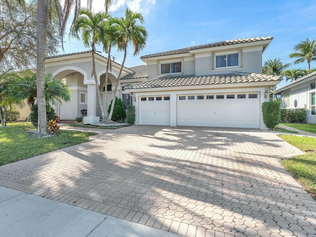 mediterranean / spanish-style home with a garage