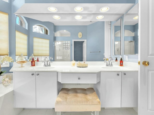 bathroom with vanity and a shower with shower door