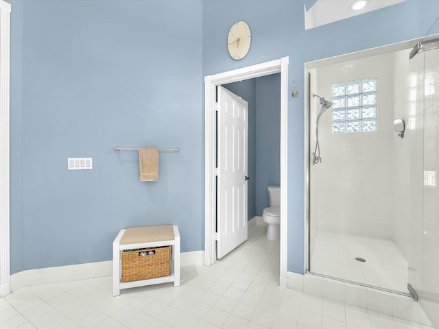 bathroom featuring walk in shower, tile patterned floors, and toilet