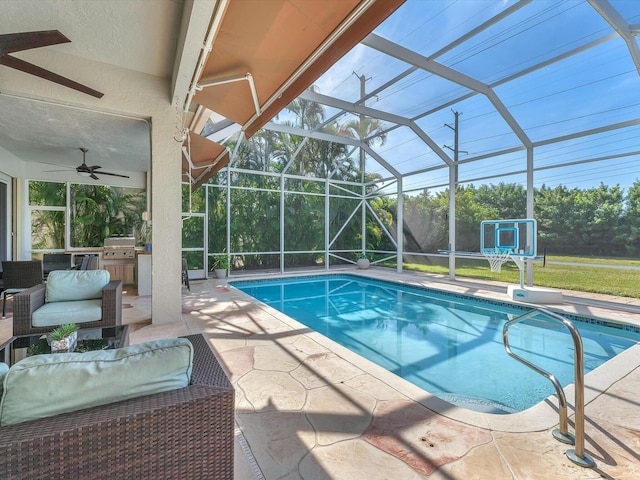 view of pool with grilling area, glass enclosure, and a patio area