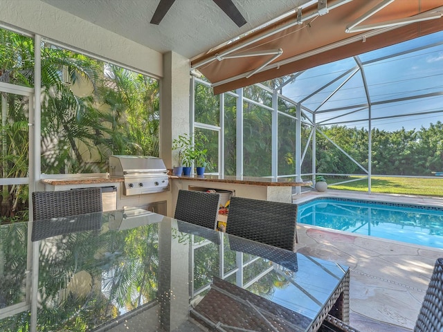 view of pool with a bar, a patio area, grilling area, and exterior kitchen