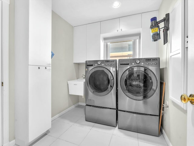 laundry room featuring washing machine and dryer and light tile patterned floors