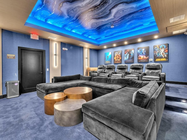 carpeted home theater featuring a tray ceiling