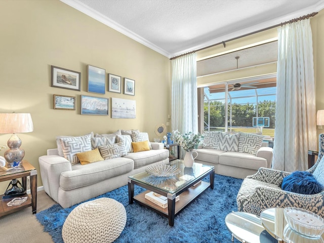 carpeted living room with crown molding, ceiling fan, and a textured ceiling