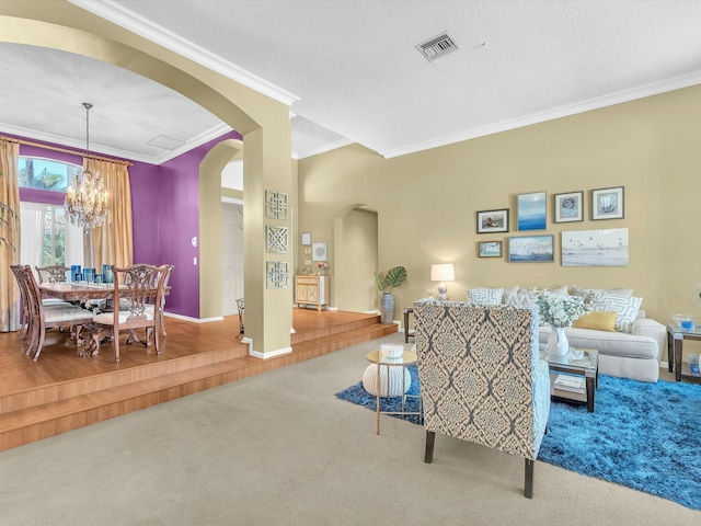 carpeted living room featuring crown molding, a textured ceiling, and a notable chandelier