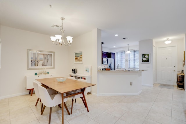 dining room featuring light tile patterned flooring and a chandelier