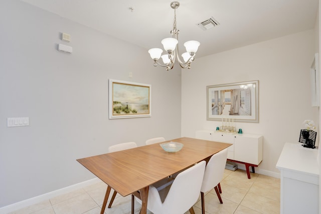 dining room featuring a chandelier and light tile patterned floors