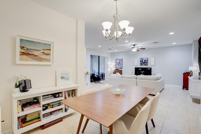 dining room featuring ceiling fan with notable chandelier and light tile patterned floors