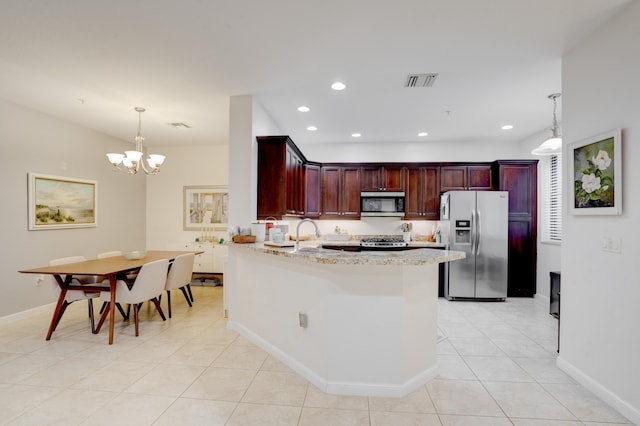 kitchen with a chandelier, light tile patterned floors, pendant lighting, stainless steel appliances, and light stone countertops