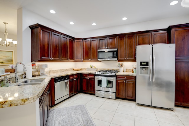 kitchen featuring pendant lighting, sink, light tile patterned floors, stainless steel appliances, and light stone counters