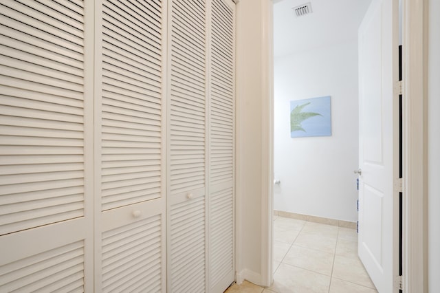 corridor featuring light tile patterned floors