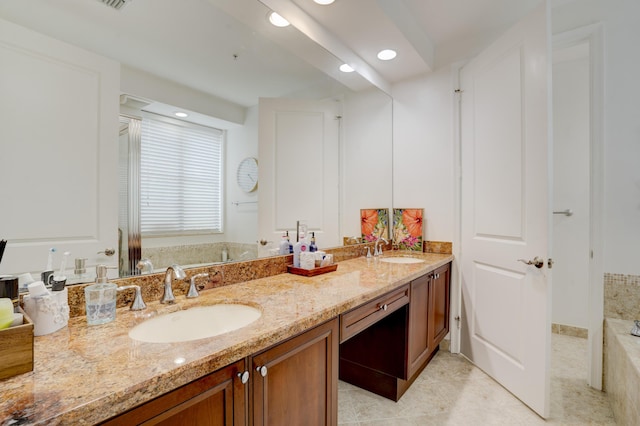 bathroom with vanity, tile patterned flooring, and a relaxing tiled tub