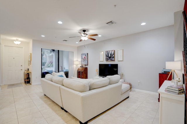 living room featuring light tile patterned flooring and ceiling fan