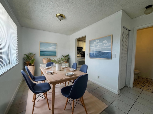 tiled dining space featuring a textured ceiling