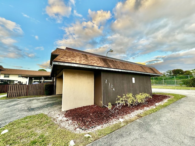 view of property exterior featuring an outbuilding