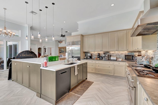 kitchen with pendant lighting, high end appliances, an island with sink, and wall chimney exhaust hood