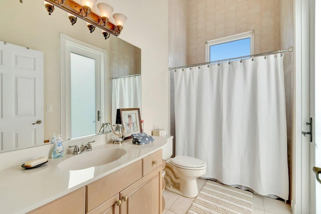 bathroom featuring vanity, tile patterned floors, and toilet