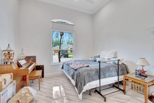 bedroom with crown molding and light wood-type flooring