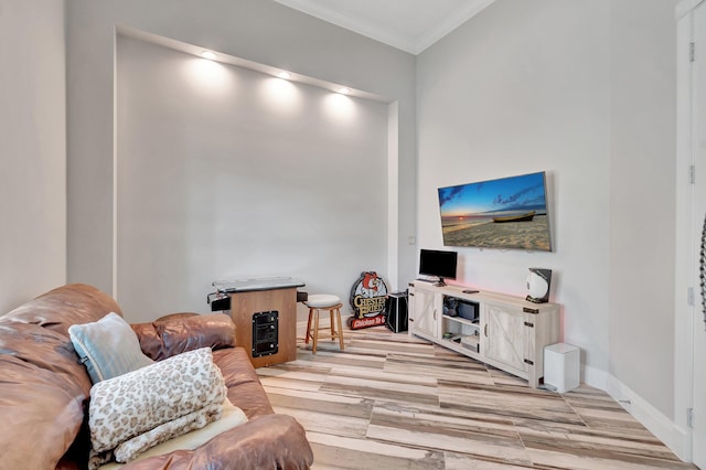 living room with crown molding and light hardwood / wood-style flooring