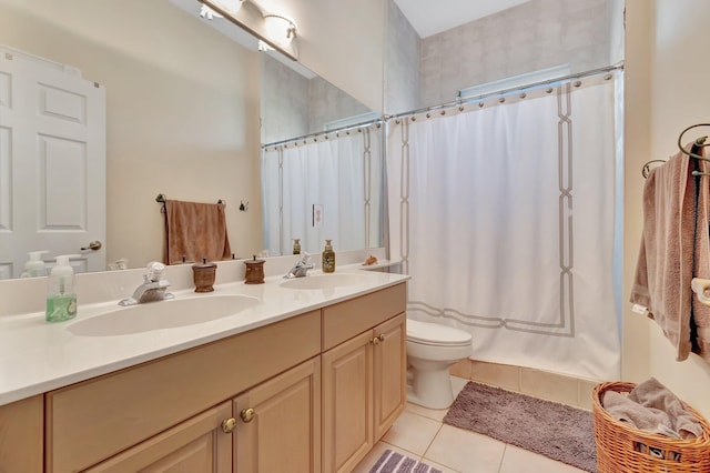 bathroom featuring vanity, tile patterned floors, and toilet