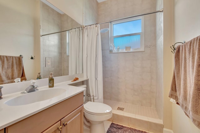 bathroom featuring walk in shower, vanity, and toilet