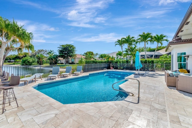 view of swimming pool with an outdoor hangout area, a patio area, and a water view