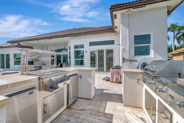 view of patio featuring a grill and an outdoor kitchen