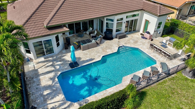 view of pool with a patio area, outdoor lounge area, and exterior bar