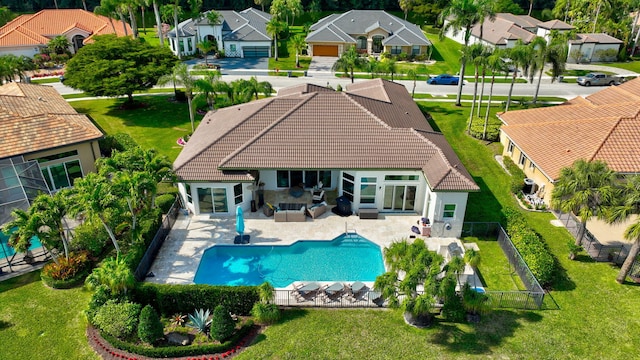 rear view of property featuring an outdoor living space and a patio