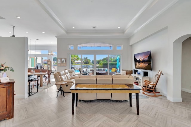 living room featuring light parquet floors, crown molding, and an inviting chandelier