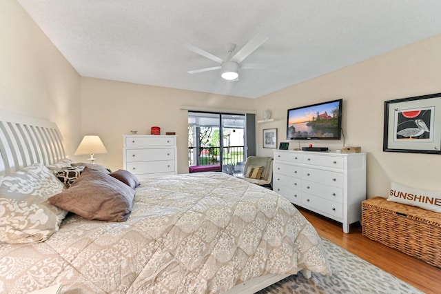 bedroom featuring wood-type flooring, a textured ceiling, access to exterior, and ceiling fan