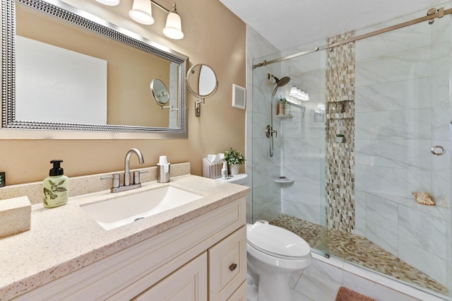 bathroom with vanity, toilet, and a shower with shower door