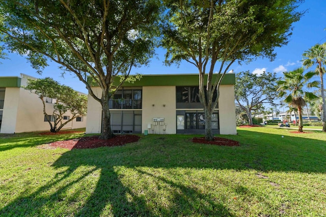 rear view of property with a yard