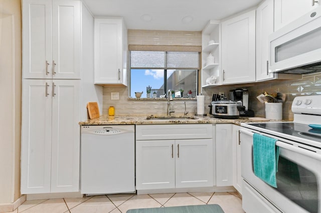 kitchen with white cabinetry, sink, and white appliances