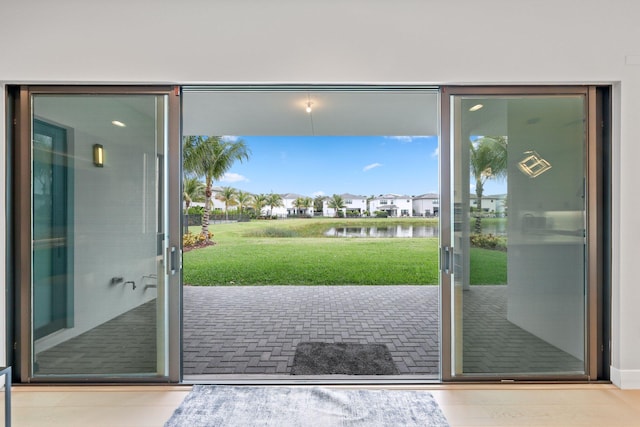 doorway with a water view and french doors