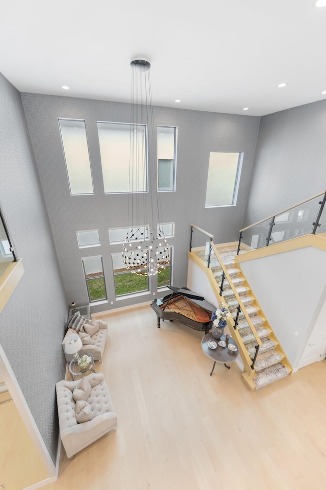 bedroom with a towering ceiling and wood-type flooring