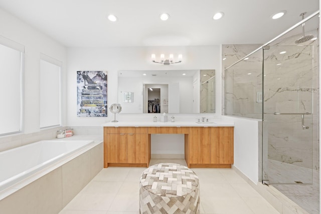 bathroom featuring tile patterned flooring, vanity, separate shower and tub, and an inviting chandelier