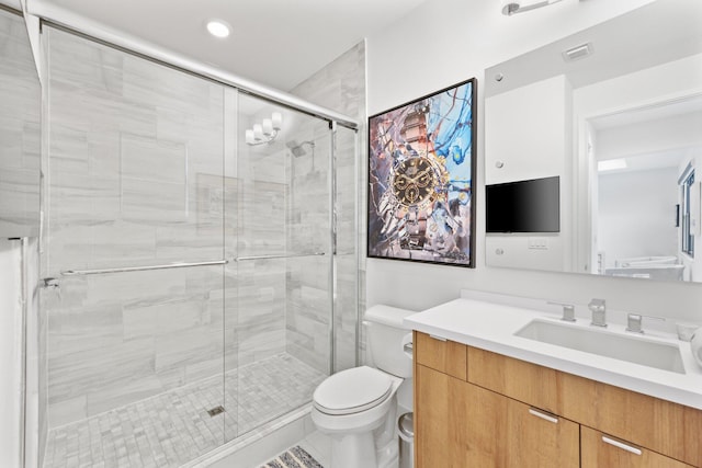 bathroom featuring vanity, an enclosed shower, and toilet