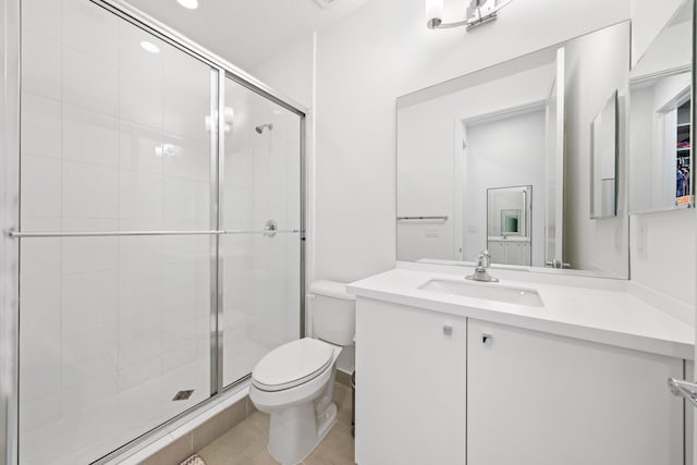 bathroom featuring an enclosed shower, vanity, and toilet