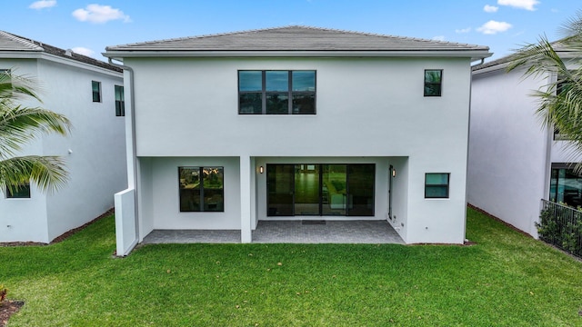 back of house featuring a yard and a patio area